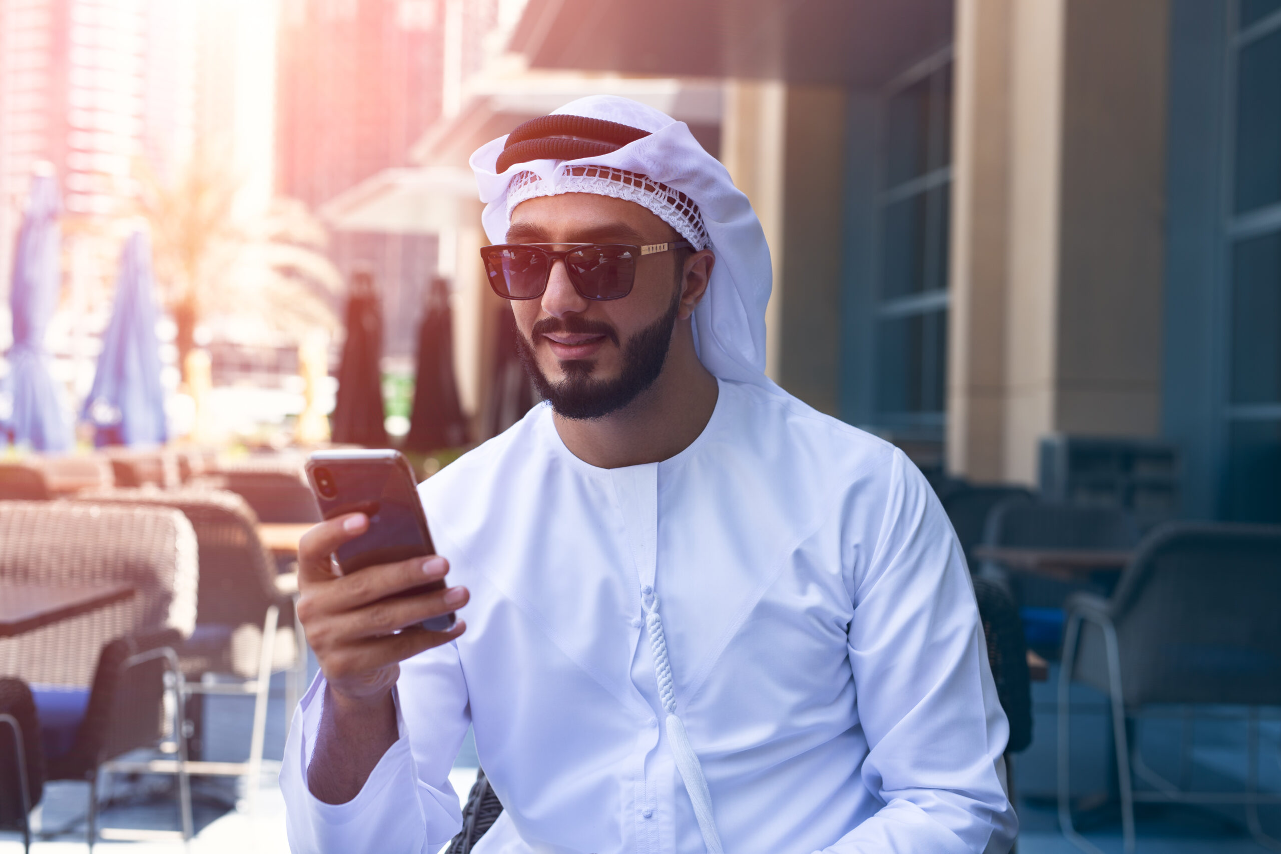 Best Dubai SIM Cards for Tourists - Arab man using a mobile phone